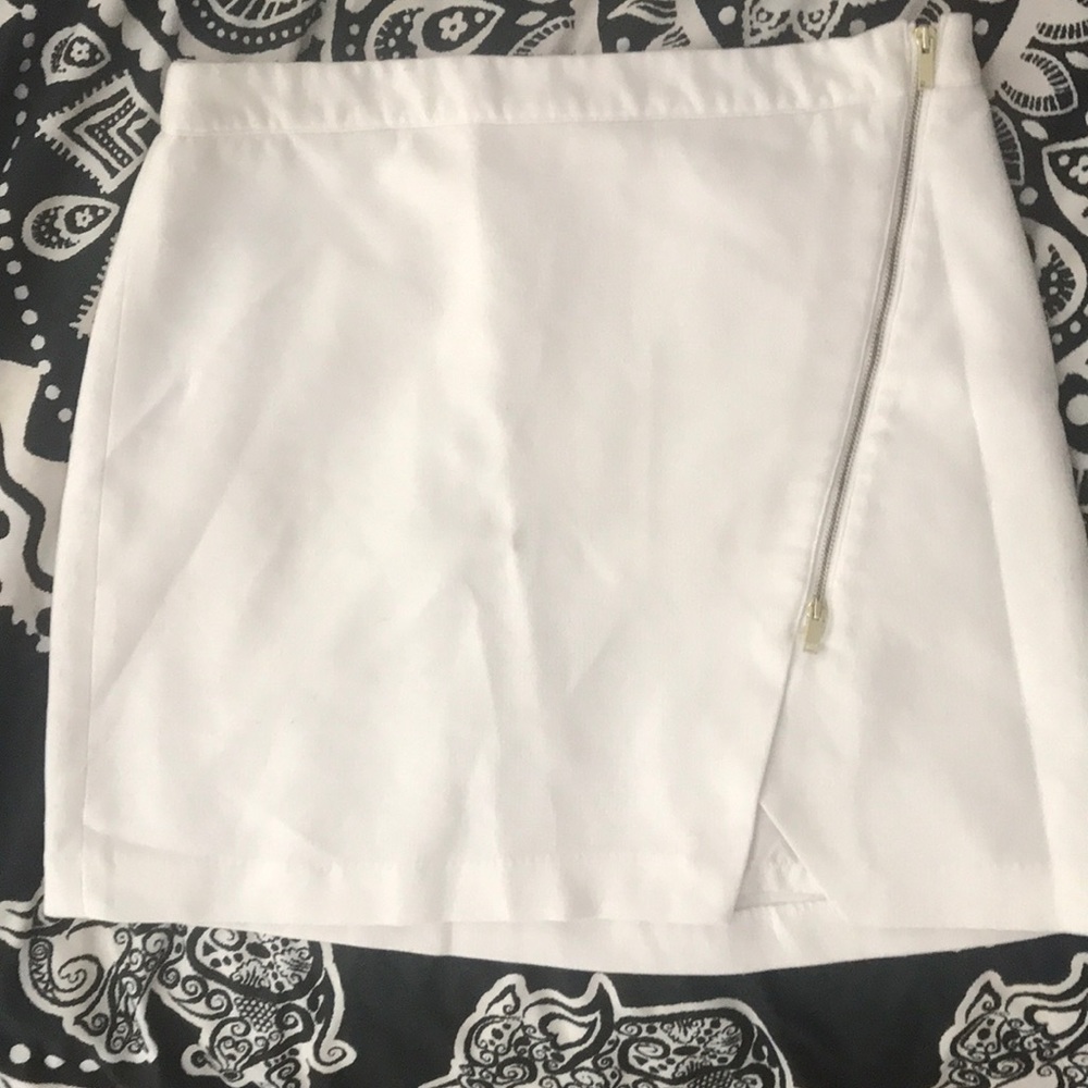 White asymmetric mini skirt.